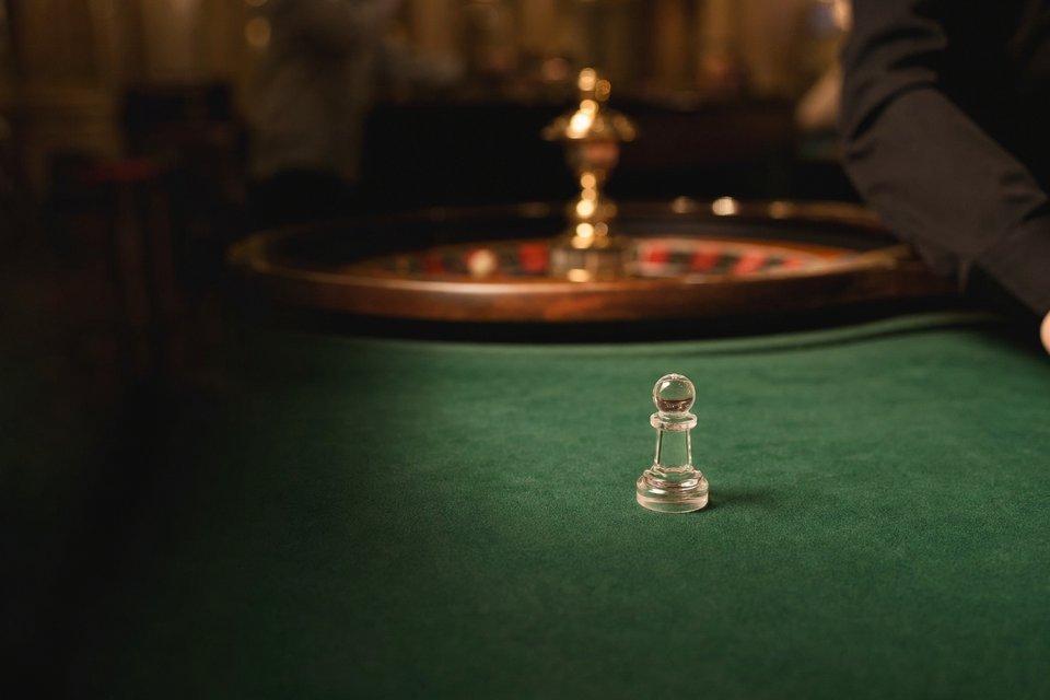A clear acrylic dolly marker standing on empty green felt (AI-generated image)
